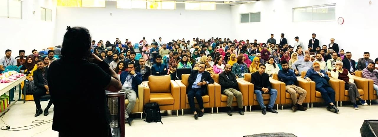 Vajramunee speaking to a full auditorium