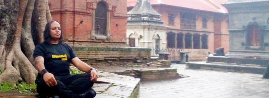 Vajramunee meditating beside an ancient tree in Nepal